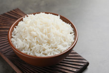 Bowl Of Tasty Cooked White Rice On Grey Table