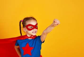 Wall Mural - concept of child superhero costume on yellow background.