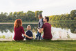 © satura_ - Children, parenthood and nature concept - Big family sitting on the grass
