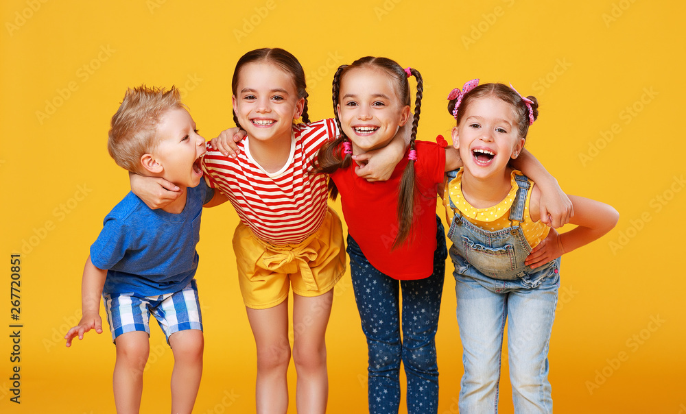 group of cheerful happy children on colored yellow background. - obrazy, fototapety, plakaty 