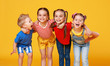 © JenkoAtaman - group of cheerful happy children on colored yellow background.