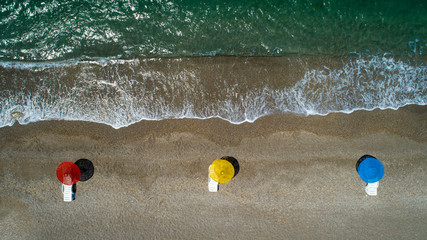 Poster - Aerial top view on the beach. Umbrellas, sand and ocean. Aerial top view photo of sun beds in popular tropical paradise deep turquoise mediterranean sandy beach in Turkey