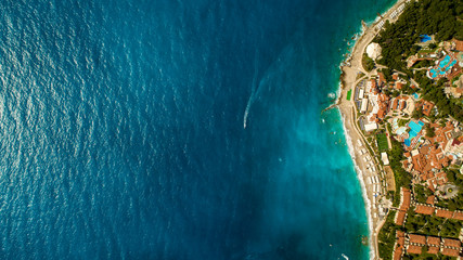 Wall Mural - Aerial view of jet ski on the blue water. People are playing a jet ski in the sea.op view. Amazing nature background.The color of the water and beautifully bright