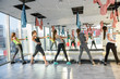 © RomanR - Group of young women training in gym with barbells