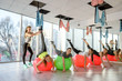 © RomanR - Young women in gym training on gymnastic ball