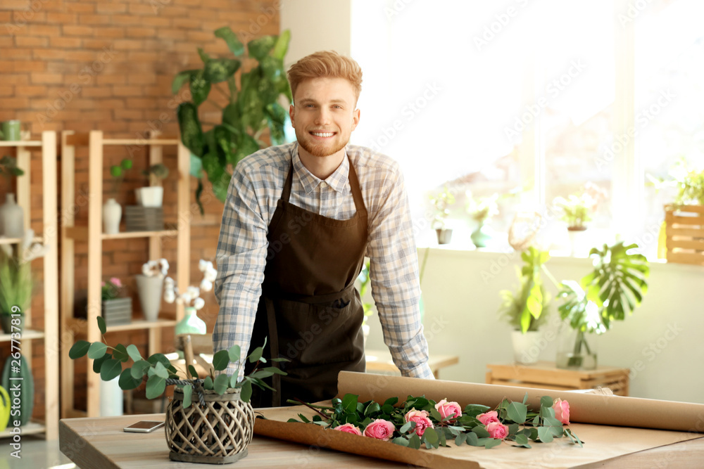 Young male florist at workplace in shop
