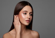 © kiuikson - Beauty photo of young brunette woman touching ear