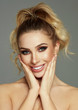 © kiuikson - Beautiful smile of blond woman with white teeth touching her cheeks