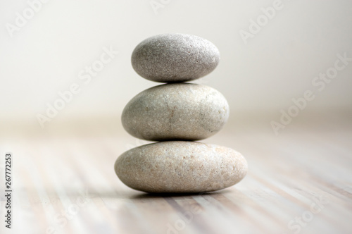 Harmony and balance, cairns, simple poise stones on wooden light white gray back Fototapet