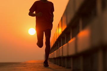 Athlete runner feet running on road, Jogging concept at outdoors. Man running for exercise.