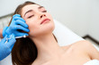 © artiemedvedev - Beautician doctor with filler syringe making injection to jowls. Masseter lines reduction and face contouring therapy. Anti-aging treatment and face lift in cosmetology clinic. Patient lying on chair
