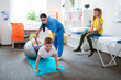 © Viacheslav Yakobchuk - Hard-working little boy leaning on a grey pilates ball
