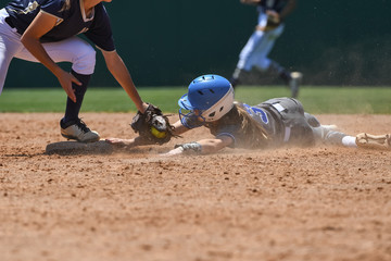 Wall Mural - Young girls playing the sport of fastpitch softball