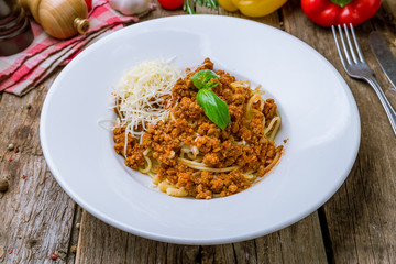 Wall Mural - Pasta spaghetti Bolognese on wooden background