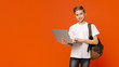 © Prostock-studio - Teenage boy with backpack using laptop, orange background