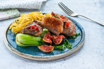 Wall Mural - Oriental duck fillets with sticky figs, pak choi and egg noodles.