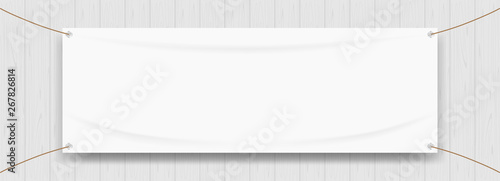 Fotografía vinyl banner blank white isolated on wood frame background, white mock up textil