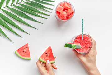 Wall Mural - Woman hands with watermelon smoothie drink glass