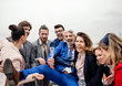© Halfpoint - A group of joyful businesspeople having a party outdoors on roof terrace in city.