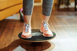 © Alliance - Closeup on fit sports woman while training using balance board