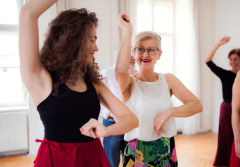 Sticker - Group of senior people in dancing class with dance teacher.