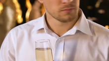 Upset Handsome Man Feeling Jealous At Party, Drinking Alcohol And Looking Around