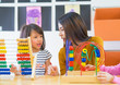 © weedezign - Asian female teacher teaching mixed race kids play toy in classroom,Kindergarten pre school concept