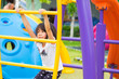 © weedezign - asia kid girl having fun to play on children's climbing toy at school playground,back to school outdoor activity