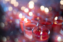 Red Candles In Clear Glass With Bokeh On The Back Eastern Temple And Palace In Asia, China Worship And Blessing.soft Focus.