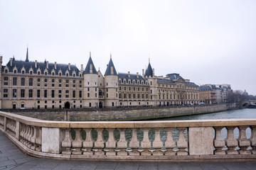 Canvas Print - View of the Castle Conciergerie, formerly royal palace and prison, presently it is part of complex Palais de Justice in Paris on a cloudy winter day, France