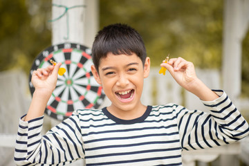 Little boy playing darts board family outdoor activity