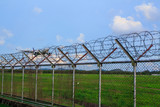 Fototapeta  - Metal fence wire, War and sky in the background in Phuket Thailand