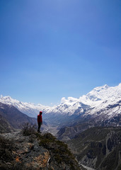 Explorer concept: Copyspace of man standing on the edge of a clift in Annapurna Circuit