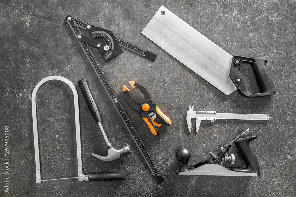 Set of carpenter's tools on grey background