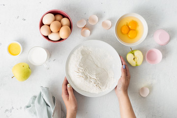 Poster - Baking ingredients cooking dough for homemade apple pie. Woman preparation muffins. Bakery background top view