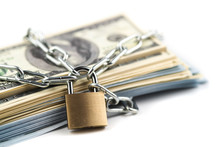 Business Safety Or Financial Protection Or Restriction Access. Heap Of Money In Chain With Padlock Isolated On White