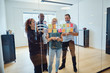 © Flamingo Images - Designers smiling during an office brainstorming session