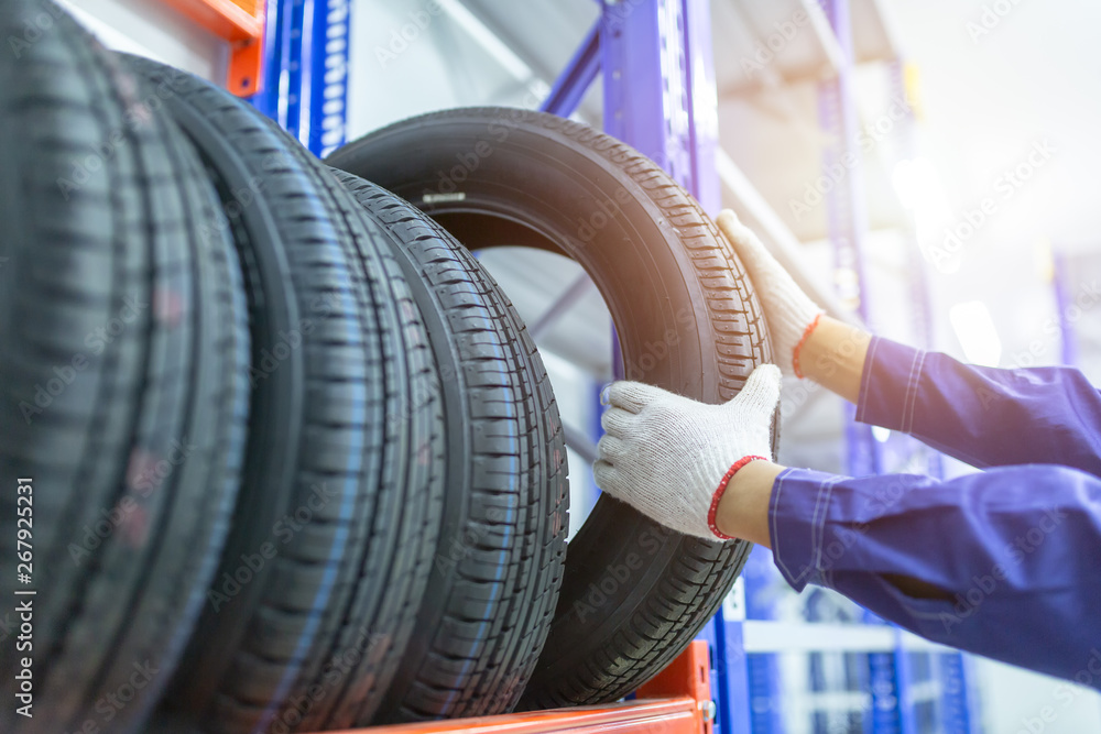 Tires in a tire store, Spare tire car, Seasonal tire change, Car maintenance and service center. Vehicle tire repair and replacement equipment. - obrazy, fototapety, plakaty 