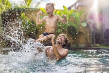 Dad And Son Have Fun In The Pool