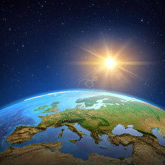 Wall Mural - sun shining over the earth from space