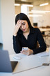© F8  \ Suport Ukraine - Portrait of tired woman talking phone near the computer at the office