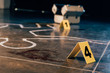chalk outline, blood stain, investigation kit and evidence markers at crime scene
