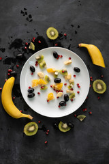 Wall Mural - fresh organic sliced or chopped in a small pieces exotic fruits, garnet, kiwi, bananas