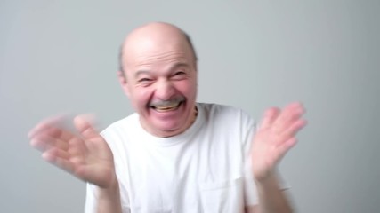 Poster - Handsome senior man smiling and clapping hands