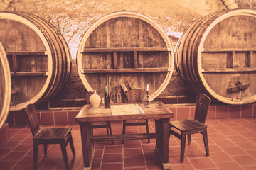 Fototapete - Old oak barrels in an ancient wine cellar. Ancient wine cellar in the ancestral castle for wine tasting. Century tradition of wine production