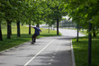 © Alexey - Man, skater rides down a hill on a skateboard in a park on a track. Skateboarding, Longboarding.