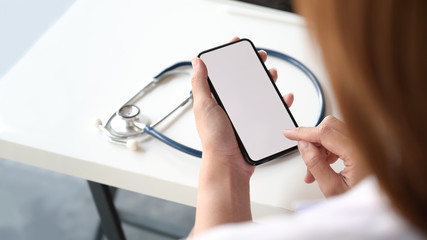 Smartphone with Blank screen in the hand of female doctor