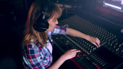 Wall Mural - Sound producer working at recording studio using soundboard and monitors