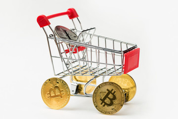 Grocery cart with Bitcoin wheels. The concept of technological breakthrough, online shopping.