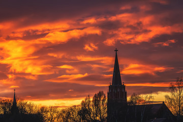 in the background of beautiful colored skies, a church is visible